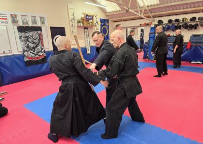 2025 UK Taikai Kukishin Hanbojutsu - Kancho helps an attendee.