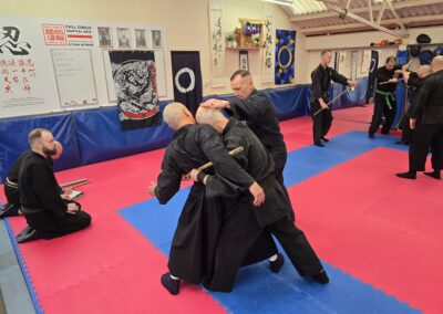 2025 UK Taikai Hanbojutsu - Kancho helps a student from Italy.