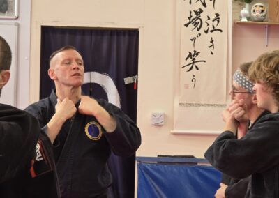 2025 UK Taikai Koto Ryu Koppojutsu - Kancho explains weak points to two members from Elkton, Maryland.